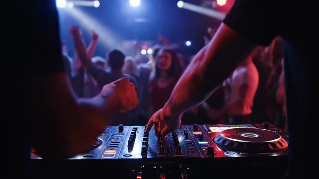 Dj operating a mixing console at a vibrant party with a cheering crowd in the background at night 4k video, animated