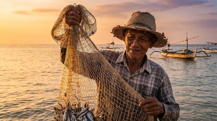 A smiling fisherman holding up a net full of fish at sunset
