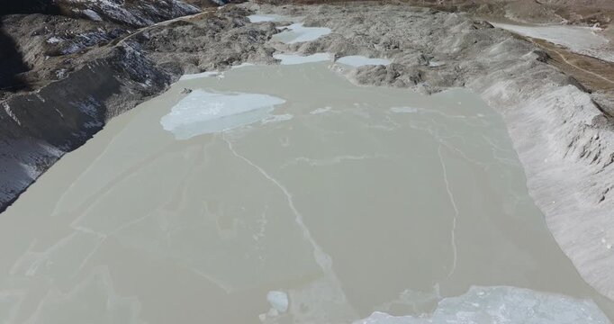 Aerial footage gliding across frozen Imja Lake in Nepal&rsquo;s Everest region, revealing the striking Chola Peak beneath clear Himalayan sky.