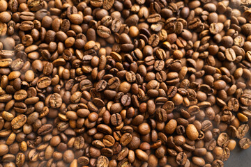 Obraz premium Close-up macro shot of roasted coffee beans, showcasing their rich texture and warm brown tones