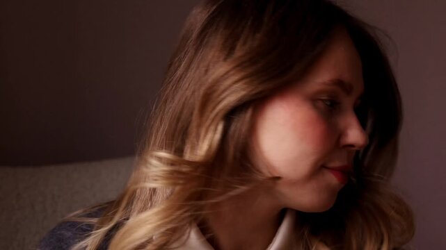 A young woman snaps her fingers multiple times in a playful rhythm, looking into the camera with a flirtatious expression and gently tapping her lip with a finger