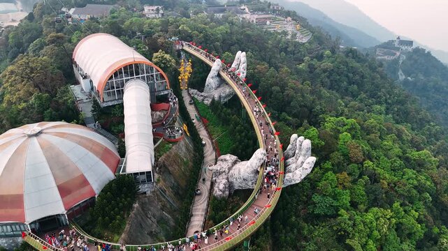 Aerial view of golden bridge held by two giant hands in the ba na hills near da nang, vietnam