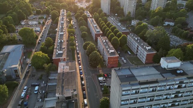 Aerial view of tree-lined mid-century slab blocks on the Alton Estate, Roehampton, South West London, at sunset