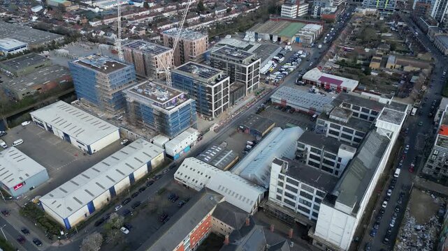 Developers construct new apartment blocks amidst industrial buildings for urban redevelopment at Crown Trading Estate in Hayes, London.