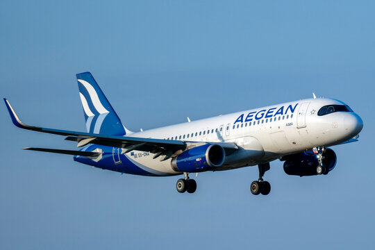Aegean Airlines airplane approaches landing at the airport during daytime with clear blue sky in the background
