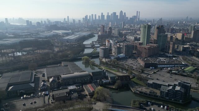 Developers build Leaside Lock apartments near the Bromley-by-Bow Tesco to expand housing, with Londons Canary Wharf in the background.