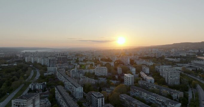 Panoramic cityscape Varna Bulgaria Chaika district sunset light. Drone perspective residential buildings sea horizon. Summer golden hour urban landscape Balkan architecture.