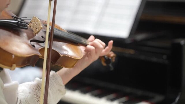 The Girl plays and trains the violin at a music school. A child's violin lesson. High quality video