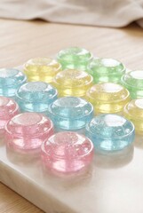 Pastel Glitter Jelly Discs on Marble Surface