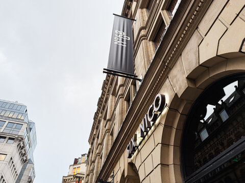 Six By Nico restaurant on a classic Manchester street with elegant stone architecture and banner sign outside