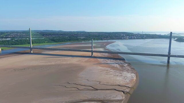 Liverpool, Merseyside, UK, June 19, 2025; Aerial 4K video footage of the Mersey Gateway toll bridge with stunning views over the River Mersey, Liverpool, UK.
