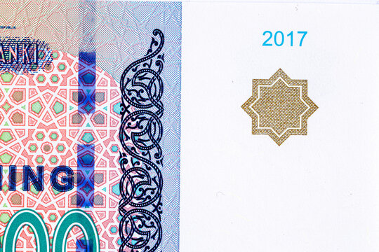 A 2017 banknote of 10000 Uzbek soums. The obverse depicts the state emblem. The reverse side of the banknote features an image of the Senate building in Tashkent.