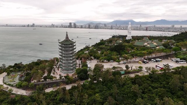 Aerial view of linh ung pagoda and the lady buddha statue with the da nang skyline in vietnam
