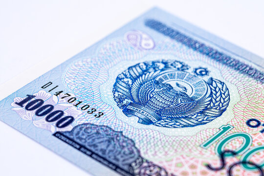 A 2017 banknote of 10000 Uzbek soums. The obverse depicts the state emblem. The reverse side of the banknote features an image of the Senate building in Tashkent.