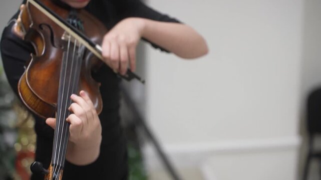 The Girl plays and trains the violin at a music school. A child's violin lesson. High quality video