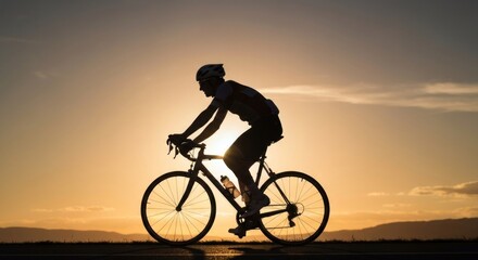 Obraz premium Silhouette of cyclist against setting sun; bike, rider, and orange sky