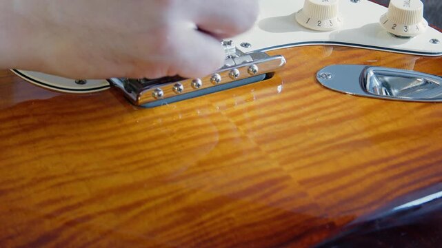 Pan across flame maple body of vintage classic Fender electric guitar