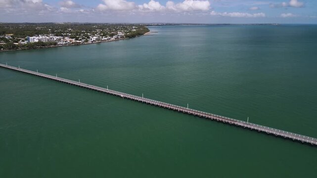 Historic tourist attraction the Urangan Pier with panoramic views of Hervey Bay Queensland Australia. Moving drone view
