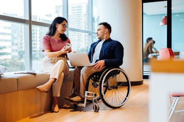 Professional friends discuss ideas in modern coworking space