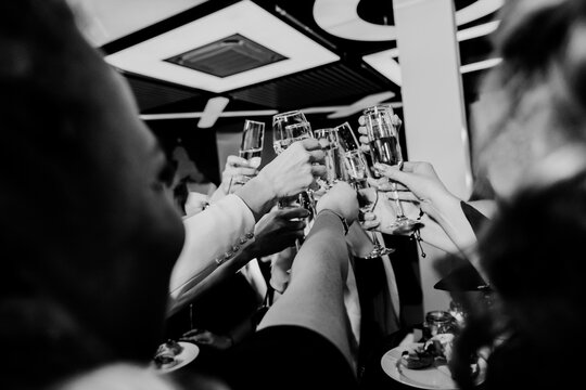People toasting champagne glasses celebrating friendship at party
