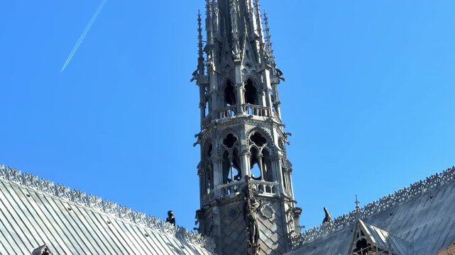 A close-up of the newly completed spire of Notre-Dame de Paris cathedral