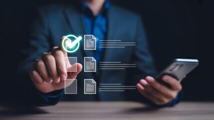 Person's hand touching glowing green checkmark on digital document list while holding smartphone finger