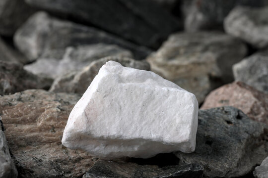 Natural gypsum (calcium sulfate). Textured rock background. Mining of critical strategic mineral, raw materials. Drywall, plasterboard, cement, plaster, agriculture soil conditioner, medical cast
