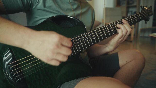 Casual Scene With Cozy Domestic Ambiance. Closeup Of Hands Playing Guitar In Warm Living Room Setting