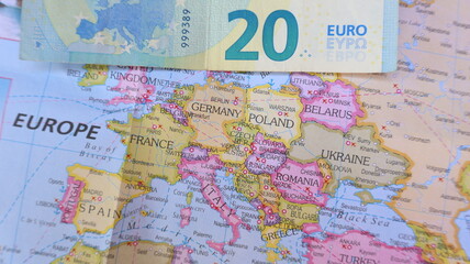 Naklejka premium Euro Bill on Europe Map - Travel Planning & Finance