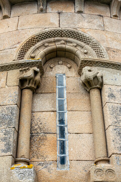 Graceful 12th-century Romanesque window of the Santa Maria de Herbon church apse with checky archivolts and carved stone capitals, Padron, Galicia, Spain