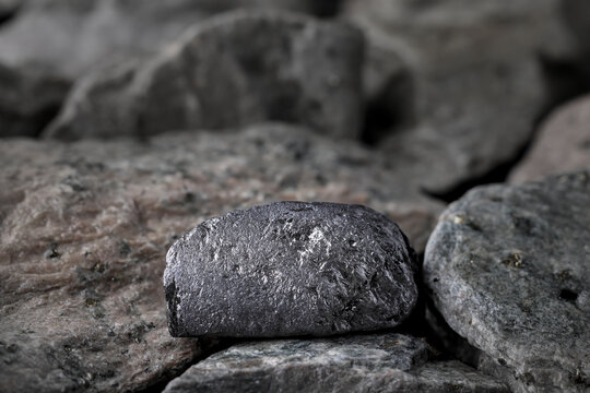 High purity graphite. Textured rock background. Mining critical, strategic mineral, raw material. Lithium-ion battery anode, refractory material, lubricant, pencil lead, nuclear reactor moderator use