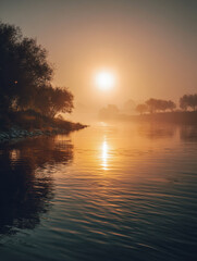 Tranquil early morning scene at a calm river with golden sunlight reflecting on gentle ripples and silhouetted trees along the misty shoreline creating peaceful ambi