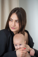 young woman holding a small child in her arms