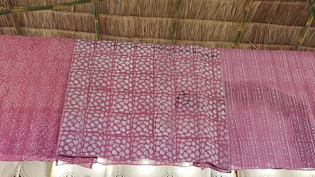 The pink textile features unique geometric designs.