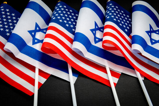 The national flag of Israel and the United States of America isolated on black. An Israeli, American relations concept.