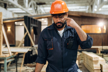 Break time, standing. Portrait of a male carpenter posing in a woodworking workshop