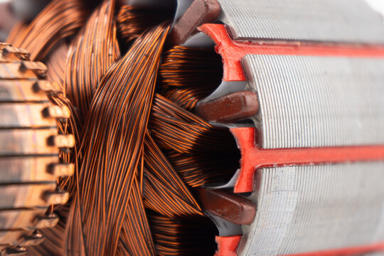Electric DC motor rotors with copper commutator and coil wire winding texture background. Magnet engine.  Starter anchor motor.