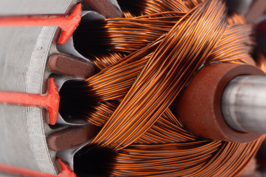 Electric DC motor rotors with copper commutator and coil wire winding texture background. Magnet engine.  Starter anchor motor.