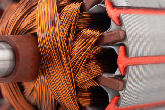 Electric DC motor rotors with copper commutator and coil wire winding texture background. Magnet engine.  Starter anchor motor.