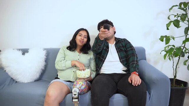 Inclusive couple with prosthetic leg watching a comedy movie