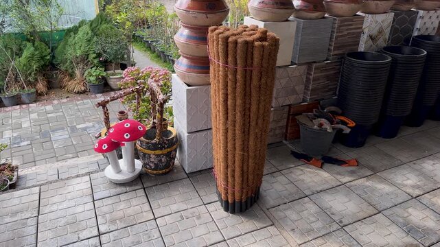 Coir Moss Poles and Garden Pots Display at Outdoor Nursery Shop
