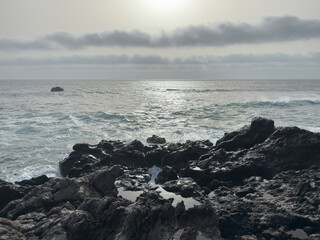 Obraz premium Rocky coastline with ocean waves and cloudy sky.. Lanzarote, Spain