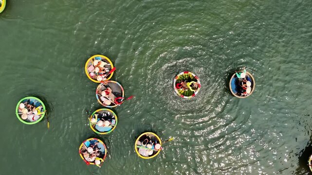 Aerial view of spinning basket boats with tourists on the thu bon river in hoi an, da nang, vietnam