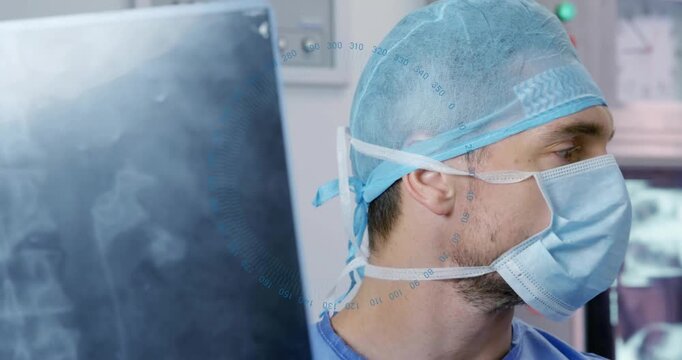Male surgeon holding radiograph inspecting X-ray as numeric overlay guiding his review to diagnose
