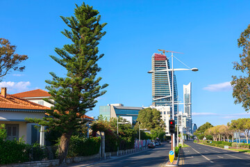 Obraz premium Urban landscape captures a street in Limassol, Cyprus, featuring distinctive high-rise under construction. Modern skyscrapers line the road beneath blue sky