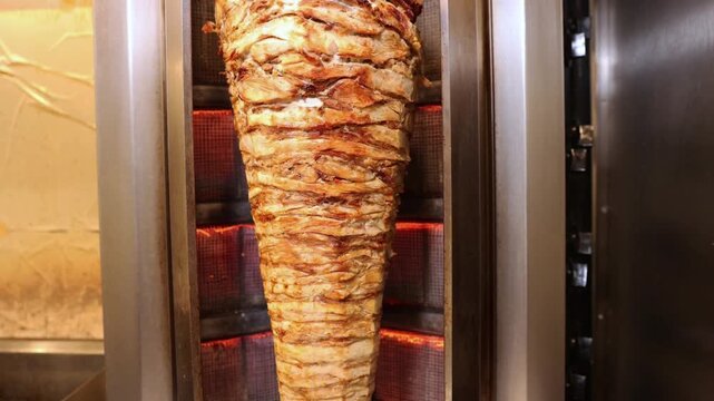 Chef Cutting Juicy Shawarma Meat in Restaurant Kitchen