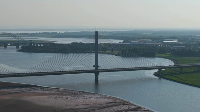 Liverpool, Merseyside, UK, June 19, 2025; Aerial 4K video footage of the Mersey Gateway toll bridge with stunning views over the River Mersey, Liverpool, UK.