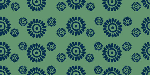 Stylized large and small blue flowers on green background. Seamless repeating vector pattern for textile print, fabric, wallpaper and decorative surface design.