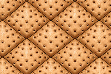 Fototapeta premium Luxury ostrich leather texture in a quilted diamond pattern, featuring iconic quill follicles and warm tan tones for a sophisticated 3D aesthetic