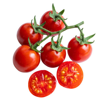Fresh cherry tomatoes on vine isolated with cut halves showing seeds